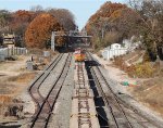 NS train O56 heads westbound with a string of empty flat cars